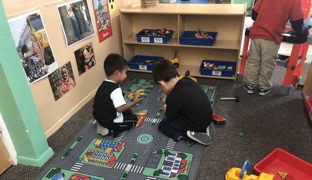 Teacher communicating with parent about child's day